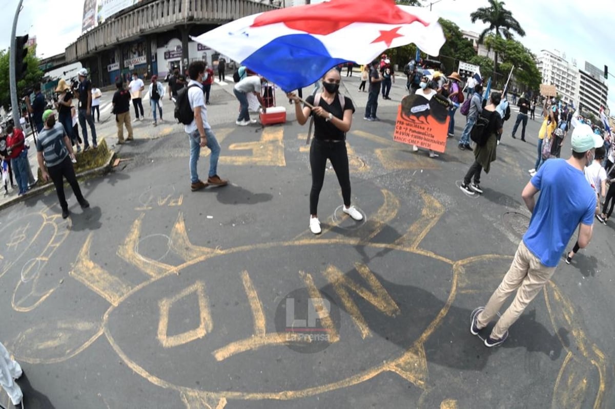 Detrás de la pancarta, una mujer